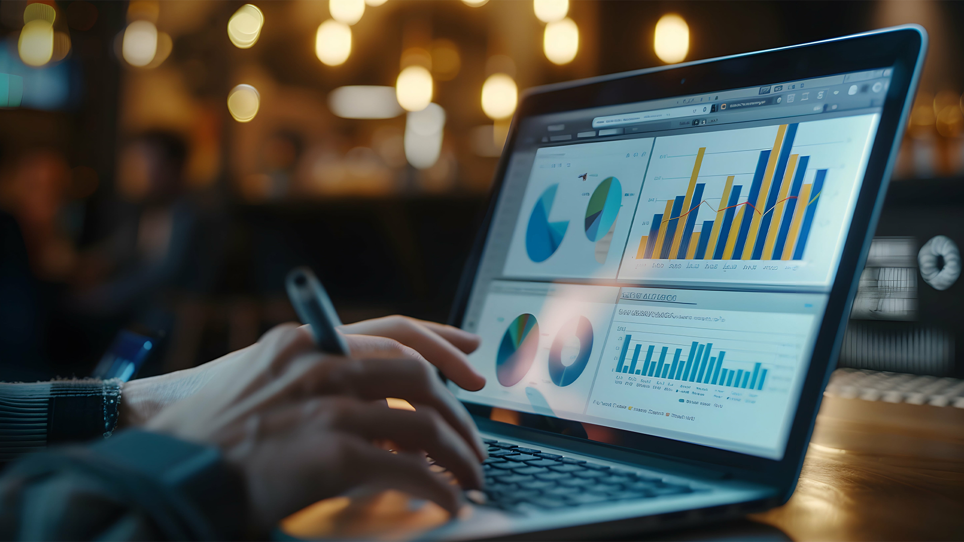 A person analyzing data on their laptop, with the screen showing graphs and tables of traffic analytics