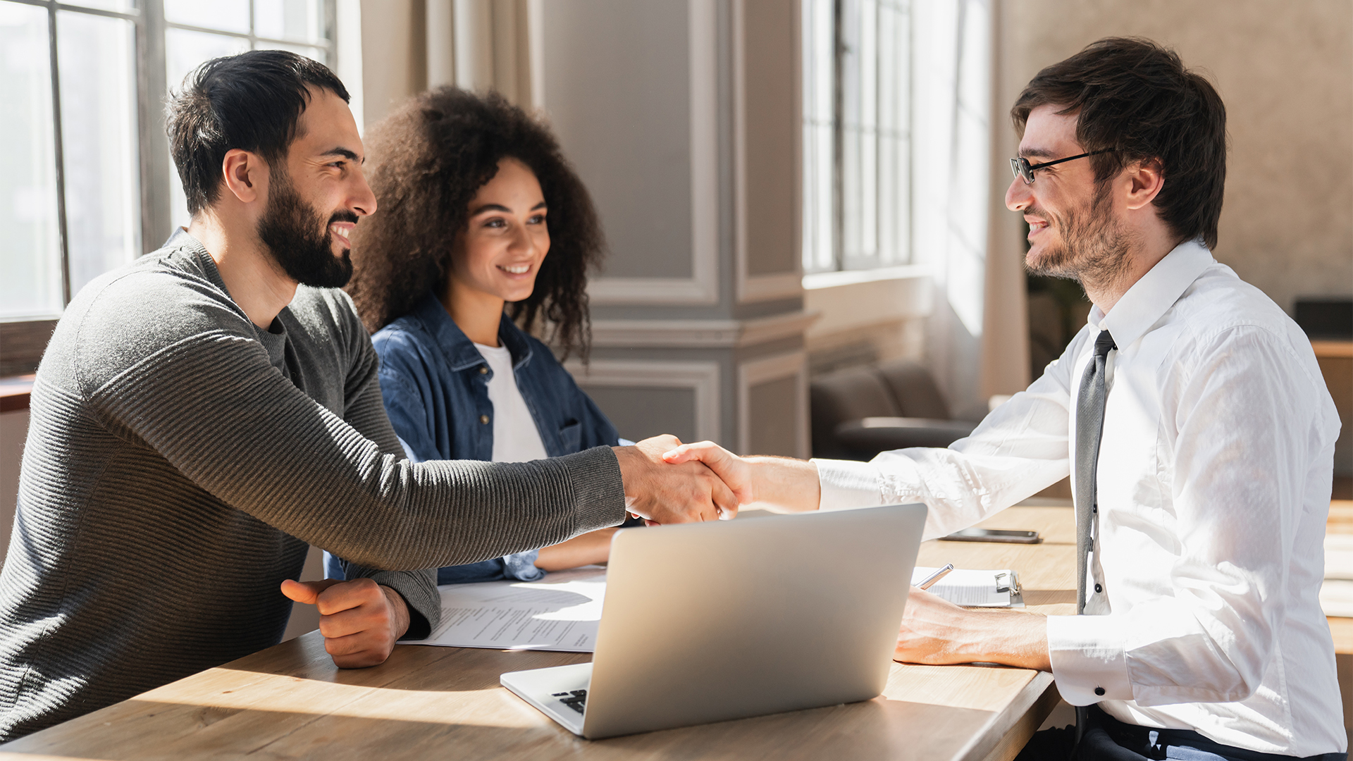 Couple handshake mortgage officer worker