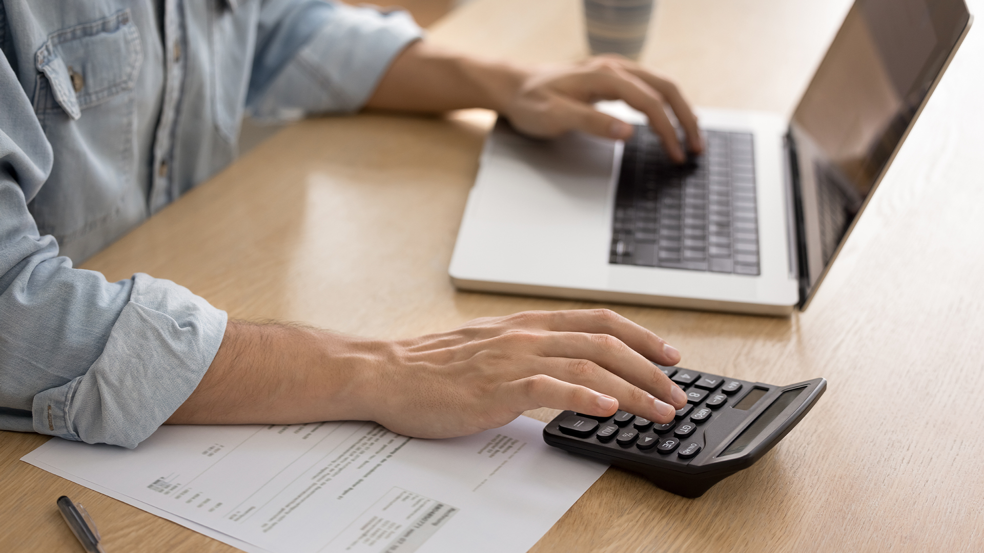man managing finances seated at desk