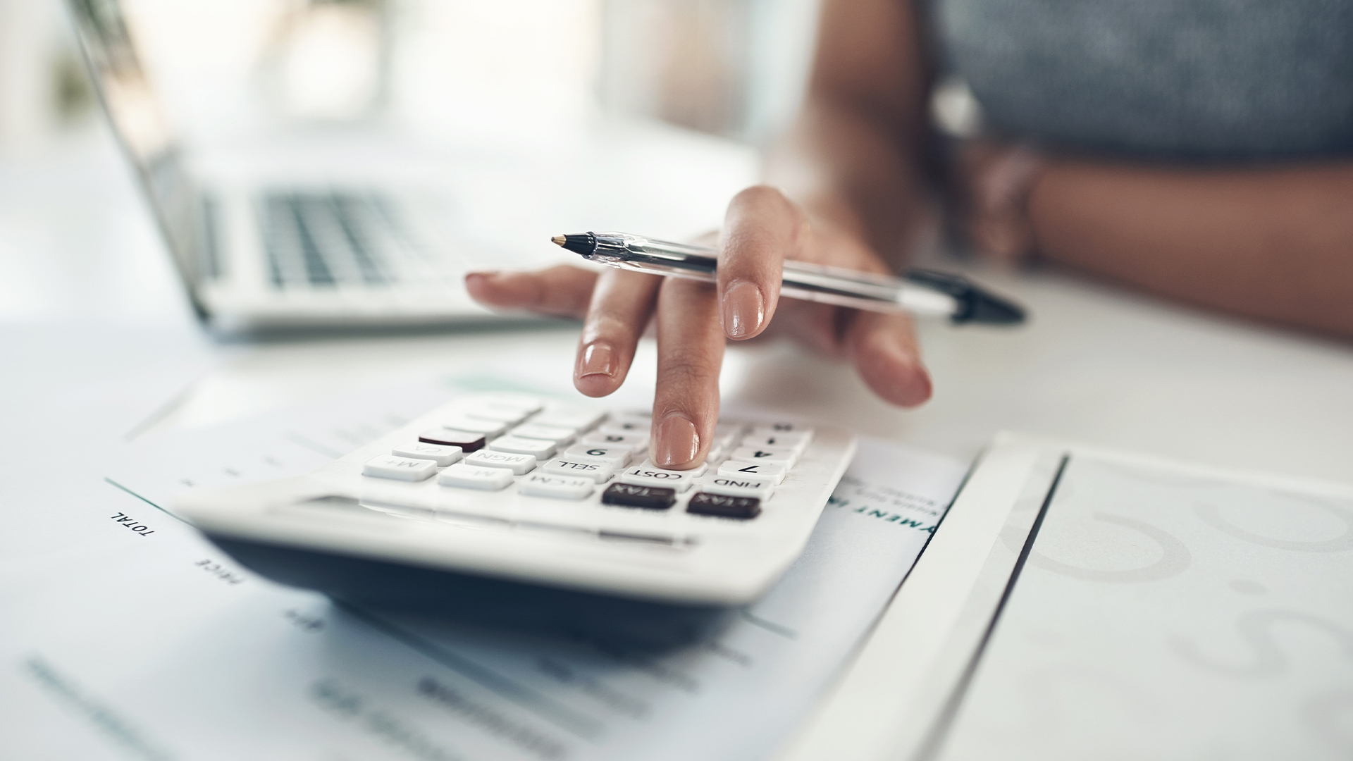 Closeup hands of female financial leader checking office staff payroll