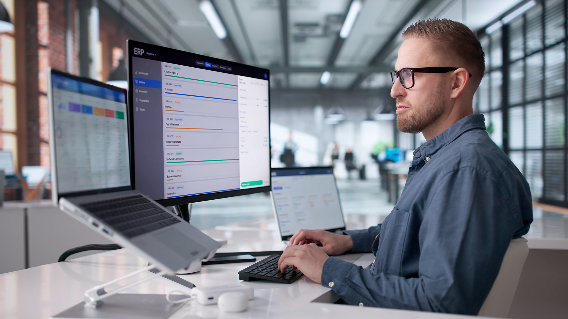 Young Professional Managing Cloud-Based ERP Software On Laptop