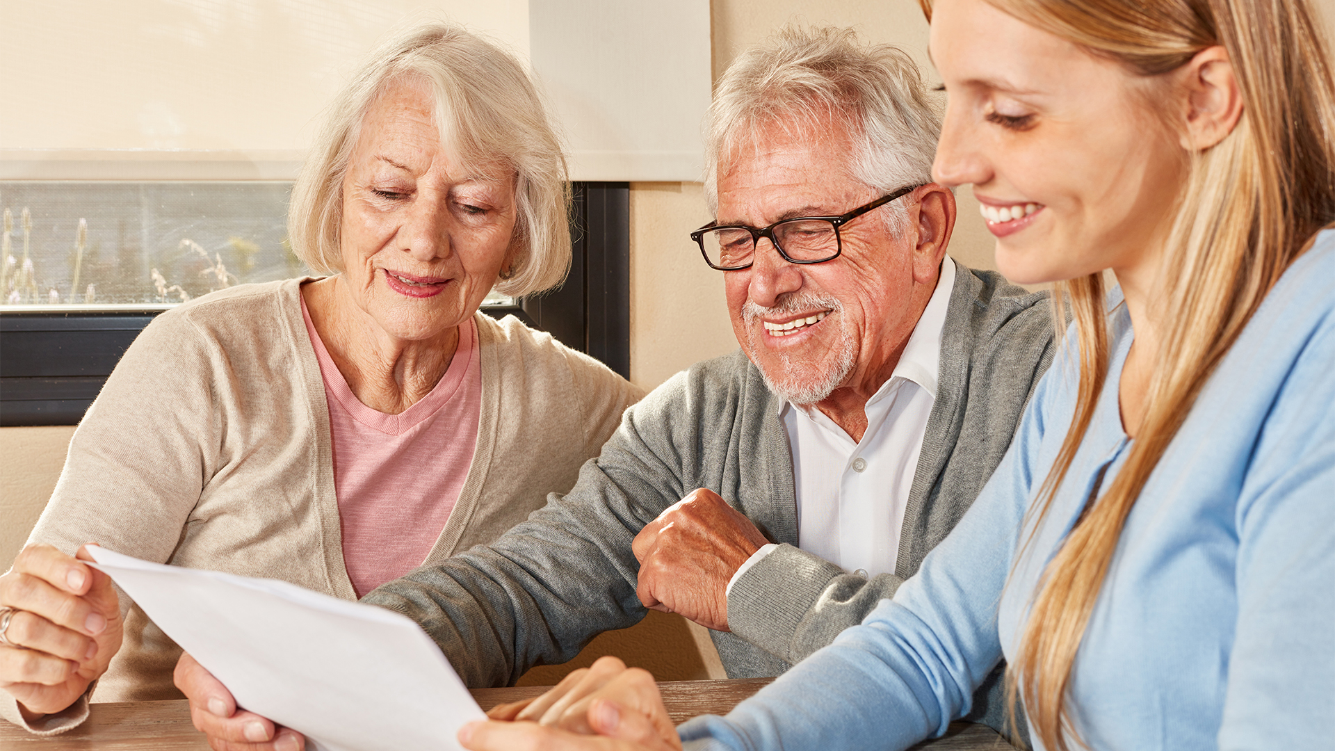 Daughter and seniors couple reading document