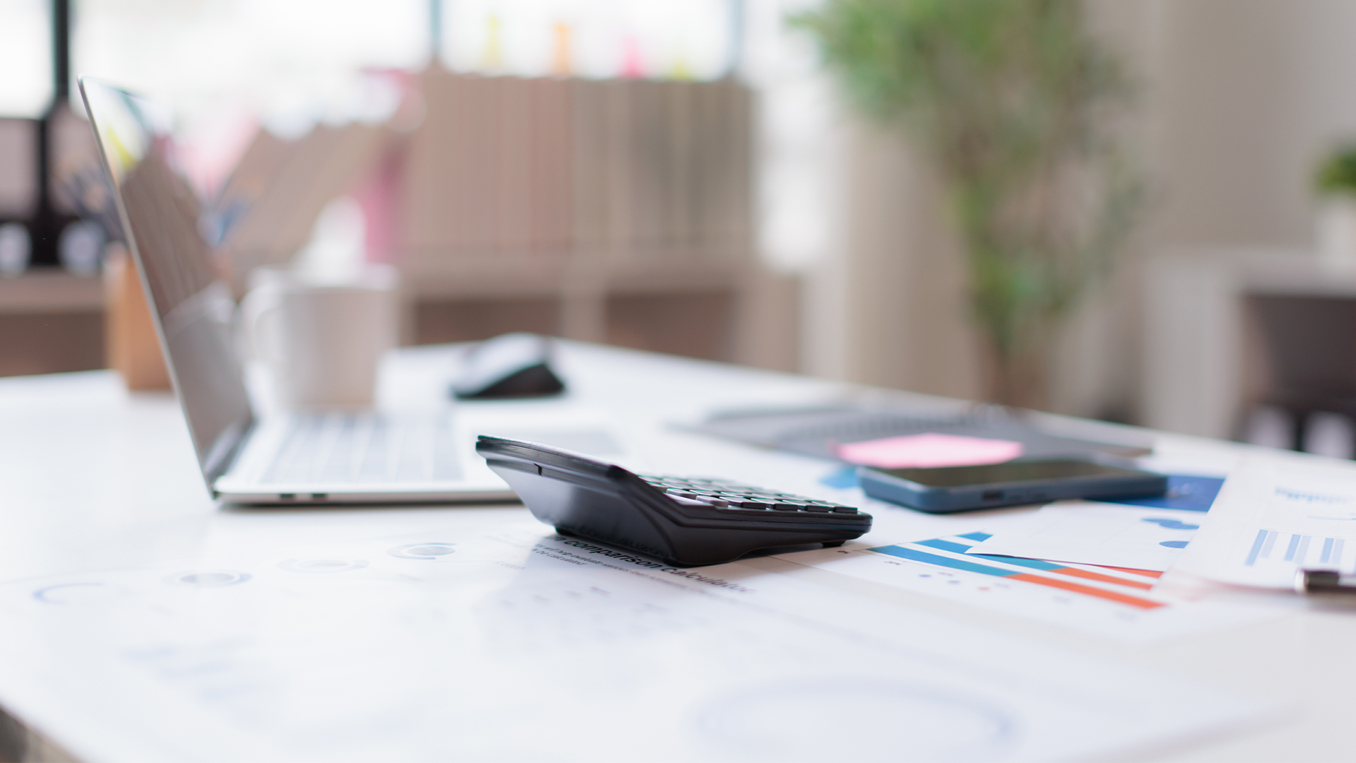 Financial accounting calculator report pen graphs and charts Preparing report.Business reports and pile of documents on gray reflection background.